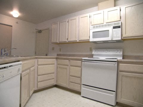 Bright Park-a kitchen with white appliances and light cabinets